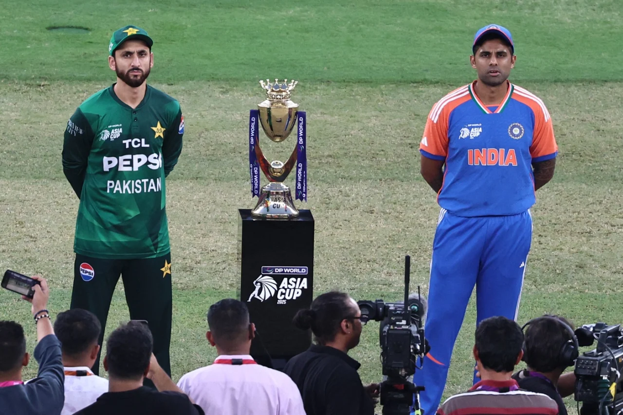 Surya Kumar Yadav and Salman Ali Agha pose with the trophy before the match